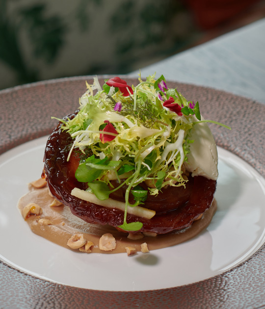 Stylish seating area in the Cromlix Hotel, Dunblane, featuring a blue sofa with colorful accents and a gallery wall of framed pictures.