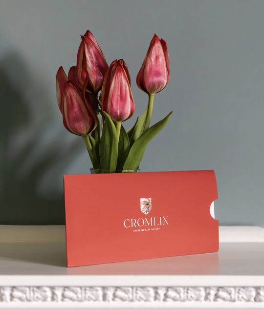 Stylish seating area in the Cromlix Hotel, Dunblane, featuring a blue sofa with colorful accents and a gallery wall of framed pictures.
