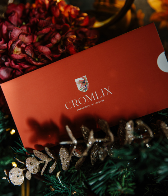 Stylish seating area in the Cromlix Hotel, Dunblane, featuring a blue sofa with colorful accents and a gallery wall of framed pictures.